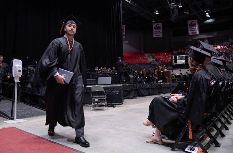 DeKalb High School graduates return to their seats after receiving their diplomas at the Convocation Center in DeKalb on Saturday, May 28, 2022.