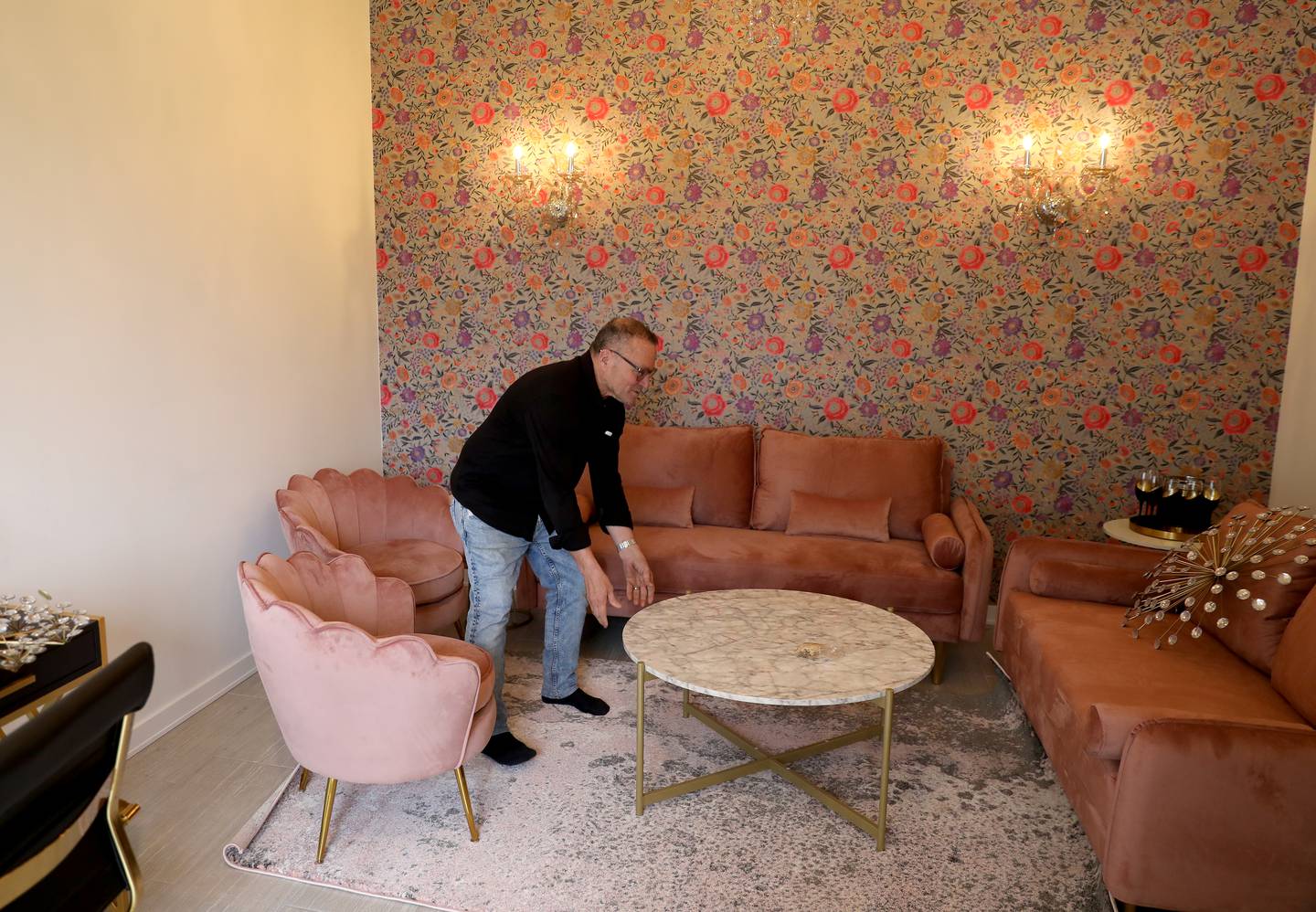 Owner Shuki Moran adjusts the seating area in the bridal room of Revelry 675, his new event venue in Batavia.