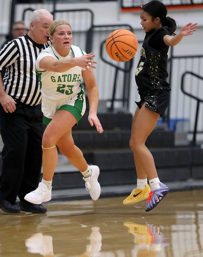 Crystal Lake South's Laken LePage passes the ball to a teammate as she is guarded by Grayslake North's Mia Leilani Gumapas during a Northern Illinois Holiday Classic semifinal girl basketball game on Tuesday, Dec. 16, 2025, at McHenry High School.