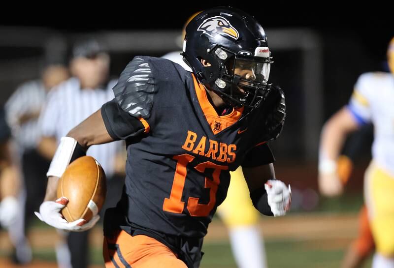 DeKalb’s Davon Grant returns an interception for a touchdown during their game against Sandburg Friday, Sept. 8, 2023, at DeKalb High School.