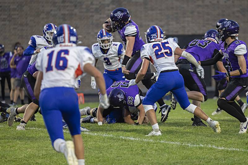 Dixon’s Aiden Wiseman leaps over the pile Thursday, Sept. 14, 2023 against Genoa-Kingston in a game at Dixon High School.