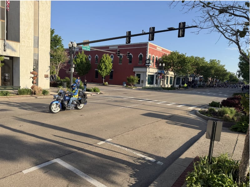 The pace motorcycle leads the runners of the 2026 Starved Rock Country full marathon southbound on La Salle Street towards Starved Rock.