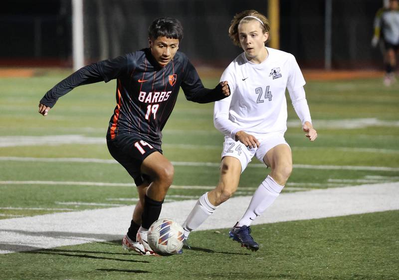 DeKalb’s Christopher Alatorre and Kaneland's Wilson Love go after a loose ball during their game Thursday, Oct. 12, 2023, at DeKalb High School.