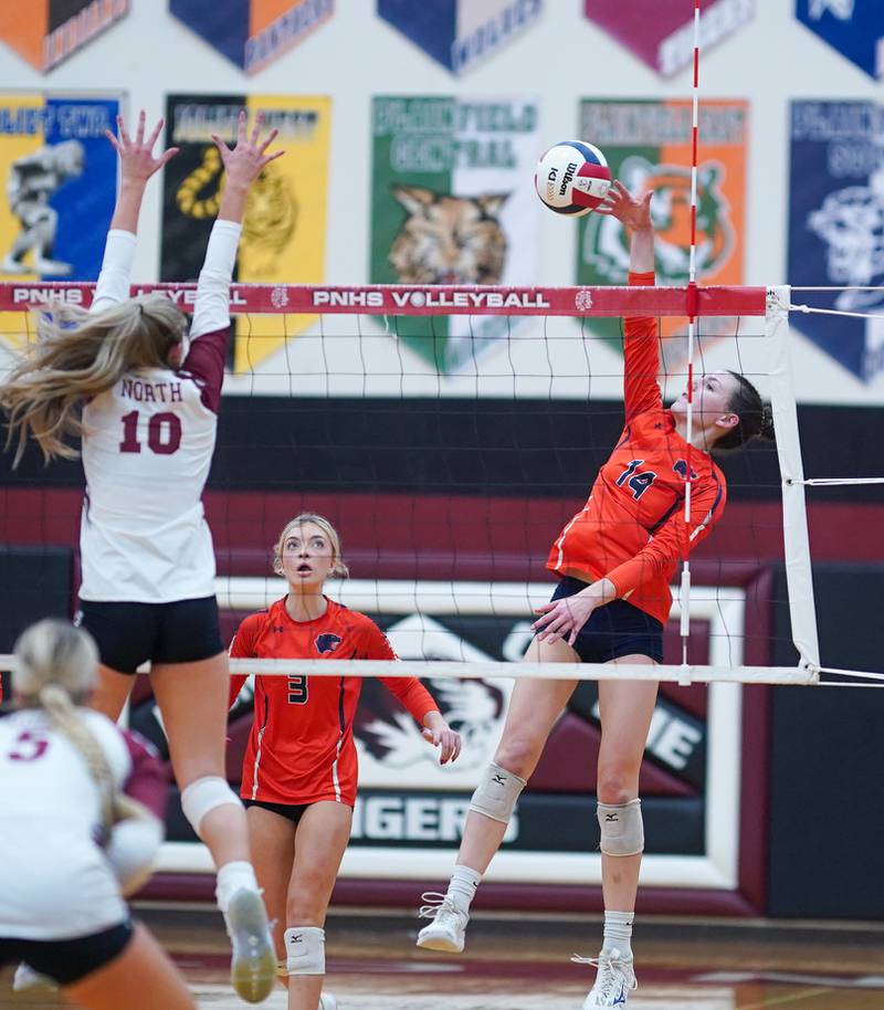 Oswego’s Mia Jurkovic (14) goes up for a kill against Plainfield North's Ella Strausberger (10) during the class 4A Plainfield North regional volleyball final at Plainfield North High School on Thursday, Oct. 26, 2023.