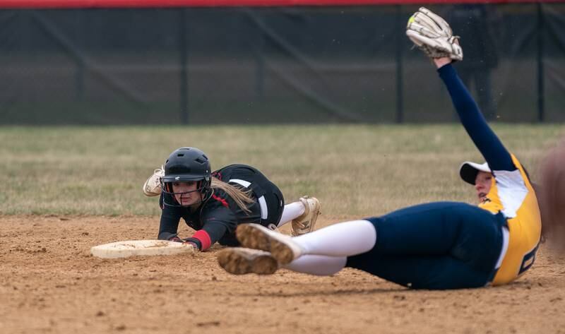 Yorkville's Kaitlyn Roberts (8) avoids the throw to second and stealing second base against Neuqua Valley during a softball game at Yorkville High School on Wednesday, April 6, 2022.