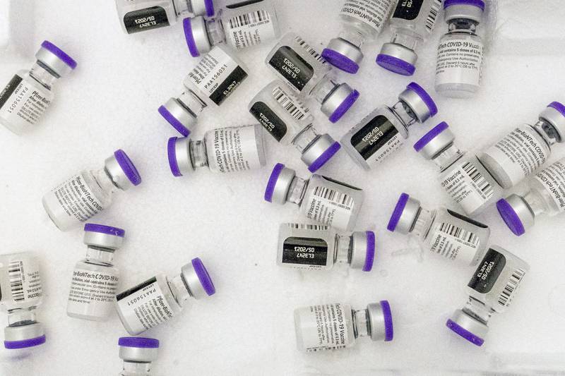 FILE - Vials of the Pfizer-BioNTech COVID-19 vaccine sit in a cooler before being thawed at a pop-up COVID-19 vaccination site in the Bronx borough of New York on Tuesday, Jan. 26, 2021. On Tuesday, Nov. 9, 2021, Pfizer asked U.S. regulators to allow boosters of its COVID-19 vaccine for anyone 18 or older, a step that comes amid concern about increased spread of the coronavirus with holiday travel and gatherings.