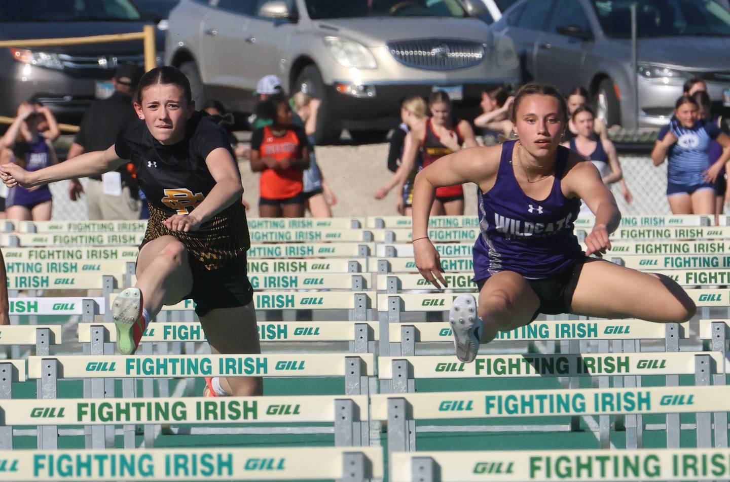 Reed Custer's Alyssa Wollenzien races Wilmington's McKenna Van Tilburg in the 100 meter hurdles during the Class 1A Sectional meet on Thursday, May 14, 2026 at Seneca High School.
