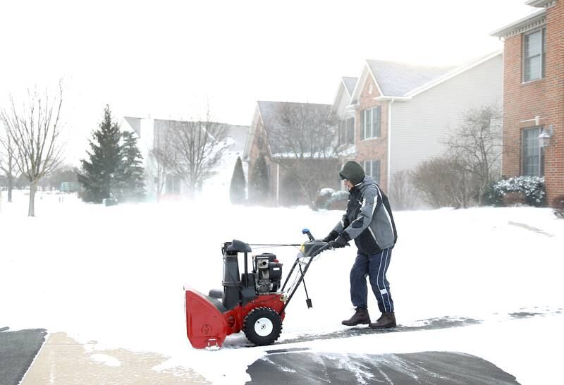 Haider Rashan uses a snow blower on his Batavia driveway as the temperatures dip below zero on Friday, Dec. 23, 2022.