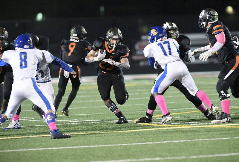 Plainfield East's Taven Washington pivots through Joliet Central's defense Friday, Oct. 25, 2019, at Plainfield East High School in Plainfield, Ill. The Bengals defeated the Steelmen, 41-0.