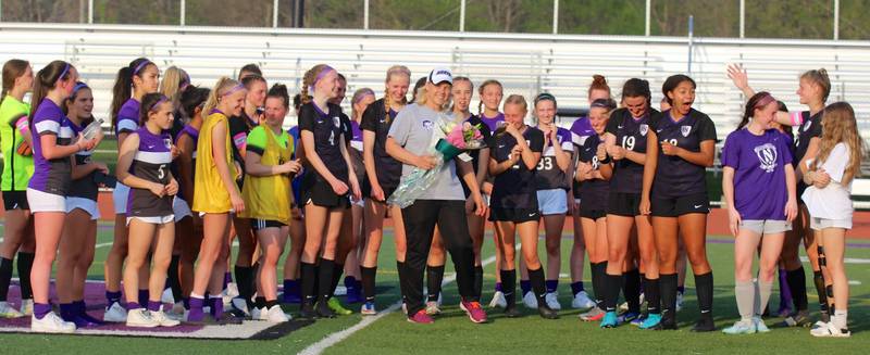Chris Tomek (gray shirt, with flowers), shown during the 2022 season, retired this year after 28 years of teaching health and coaching soccer at Downers Grove North.