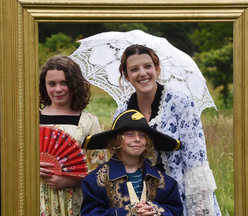 Katie Smith of St. Charles, middle, poses for a family portrait with her daughter, Zooey, 11, left and son Leo, 9, in the “Little Louvre” during the Voyage en France event at Cantigny Park on Saturday, July 20, 2024 in Wheaton.