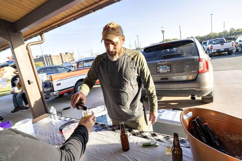 Home brewer Jason Brown of Coleta gives out a sample of his golden ginger beer Saturday, Oct. 8, 2022 at Sterling Main Streets Hops on the Rock.