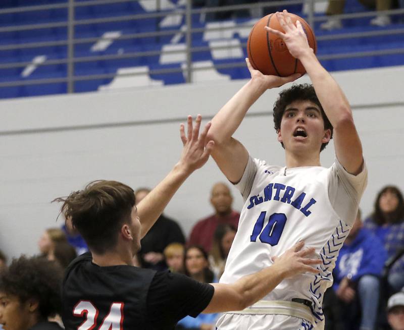 Burlington Central's Myles Lowe shoots the ball over Huntley's Ryan Sweeney during a Fox Valley Conference boys basketball game on Friday, Dec. 15, 2023, at Burlington Central High School.