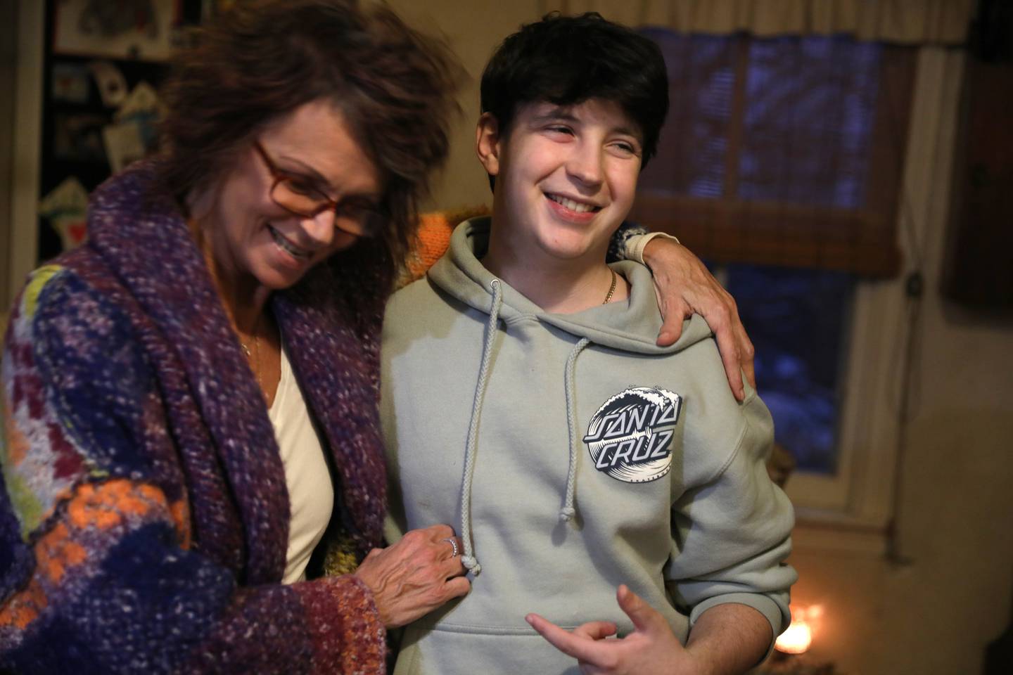 Brice Worley, 16, a junior at Batavia High School, shares a laugh with his mom, Tami Wilson, in the kitchen of their Batavia home. Worley was born with a brain tumor that was dormant until 2019. He hopes to study to become a paramedic.