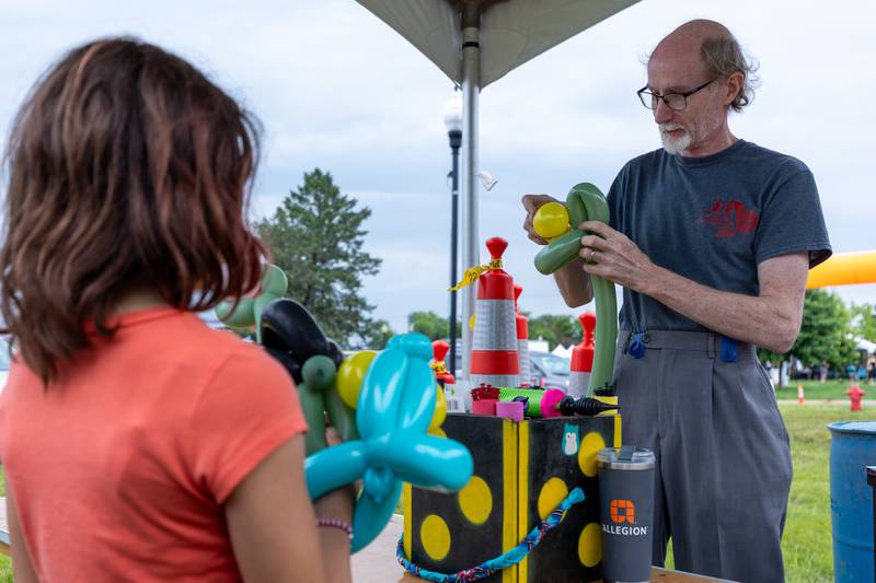(left to right) Sophia Schirmer watches as Calen Smith creates balloon animal at the annual Shrimp Fest on Saturday, June 7, 2025 at Rotary Park in Princeton.