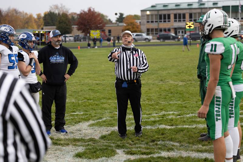 Coaches and captains look on as the referee conducts the coin toss ahead of Dwight's 43-14 victory over Clifton Central in second round playoffs on Saturday, Nov. 8, 2025.