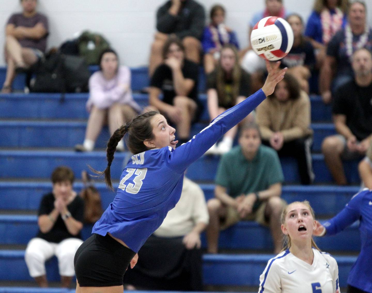 St. Charles North’s Haley Burgdorf tips the ball over the net during a game at Rosary in Aurora on Monday, Aug. 21, 2023.