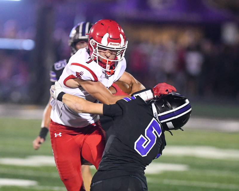 Hinsdale Central's ball carrier James Skokna, left, gets wrapped up by Downers Grove North's defender Max Troha (5) during the game on Friday Sept. 12, 2025, held at Downers Grove North High School.