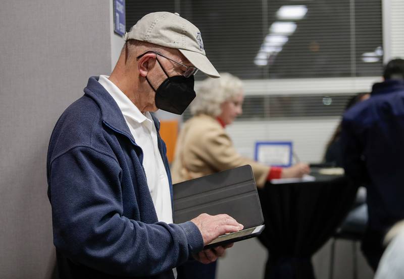 Tom Marsh of Hinsdale checks election results during U.S. Rep. Sean Casten’s watch party at Chicagoland Laborers' District Council in Burr Ridge, Ill. on Tuesday, Nov. 8, 2022.