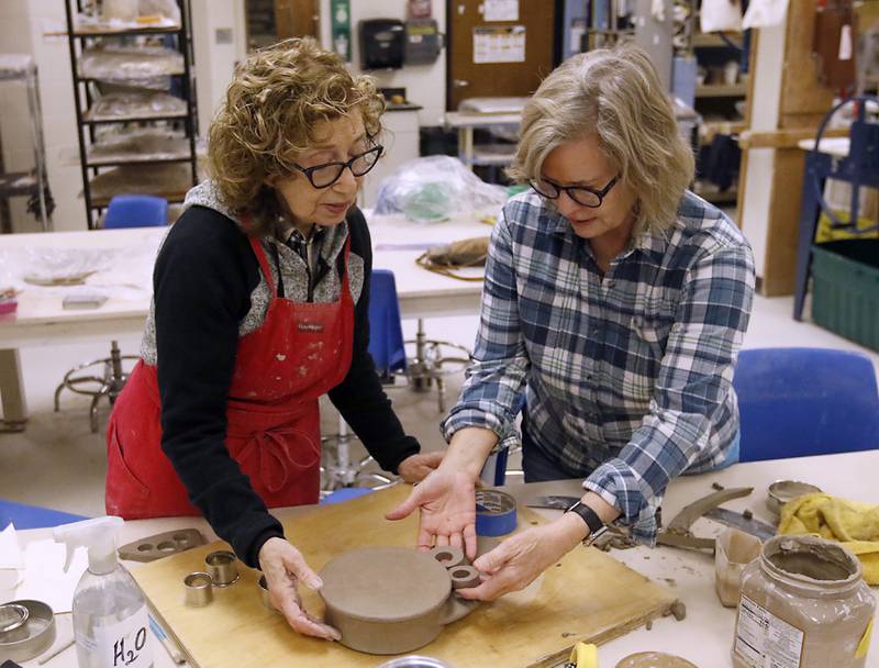 Josie Roscell and Susan Clough discus where Roscell would like to add more elements to the clock that Roscell is making as part of her advance ceramics class on Thursday, Feb, 6, 2025, at McHenry County College.