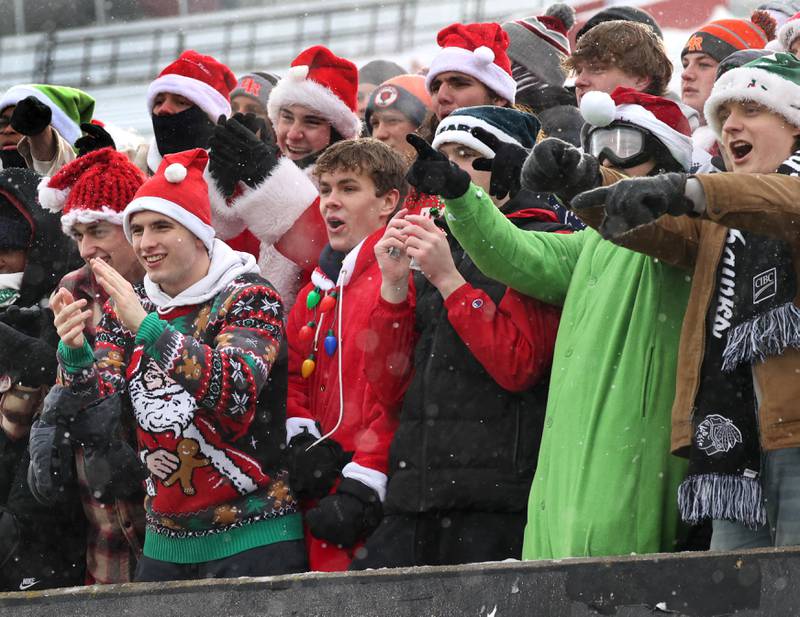 Brother Rice fans are dressed for the season as they cheer on their team Wednesday, Dec. 3, 2025, during their IHSA Class 7A state chamionship game in Huskie Stadium at Northern Illinois University in DeKalb.