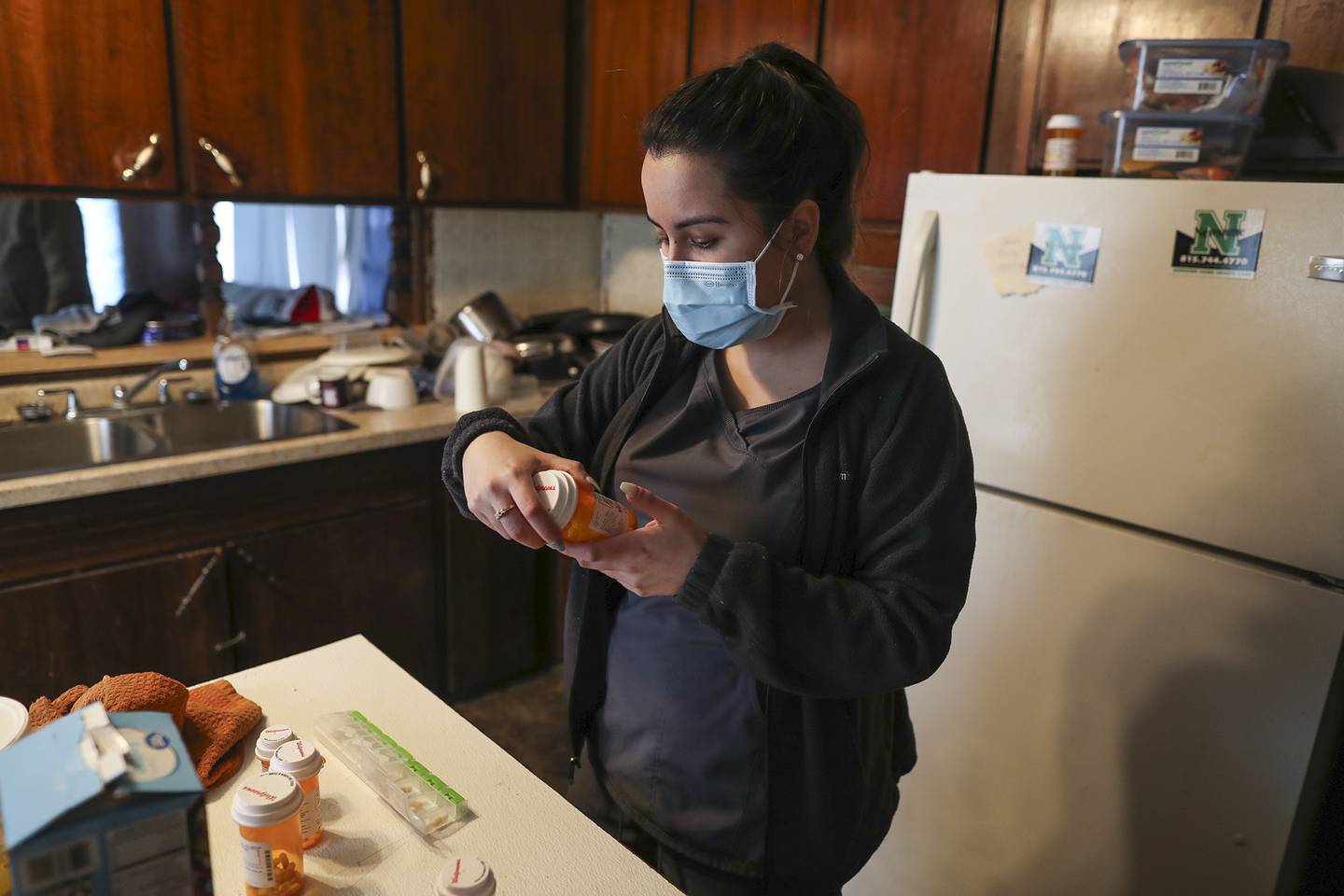 Marlene Lara prepares the weeks medication for one of the Will-Grundy Medical Clinic's clients on Friday, Feb. 12, 2021, in Joliet, Ill.