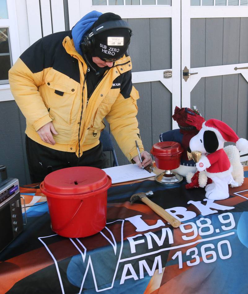 WLBK Radio host TD Ryan updates the donation totals Thursday, Dec. 5, 2024, during Freezin’ For Food in the Hy-Vee parking lot off of DeKalb Avenue in Sycamore. WLBK’s Freezin’ For Food collects non-perishable food items and monetary donations to help restock The Salvation Army’s food pantries in DeKalb County.