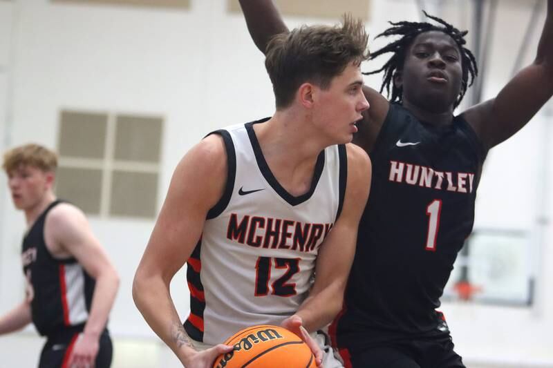 McHenry’s Caleb Jett, left, drives against Huntley’s Sheldon Bonsu in varsity boys basketball on Wednesday, Jan. 15, 2025, at McHenry High School in McHenry.