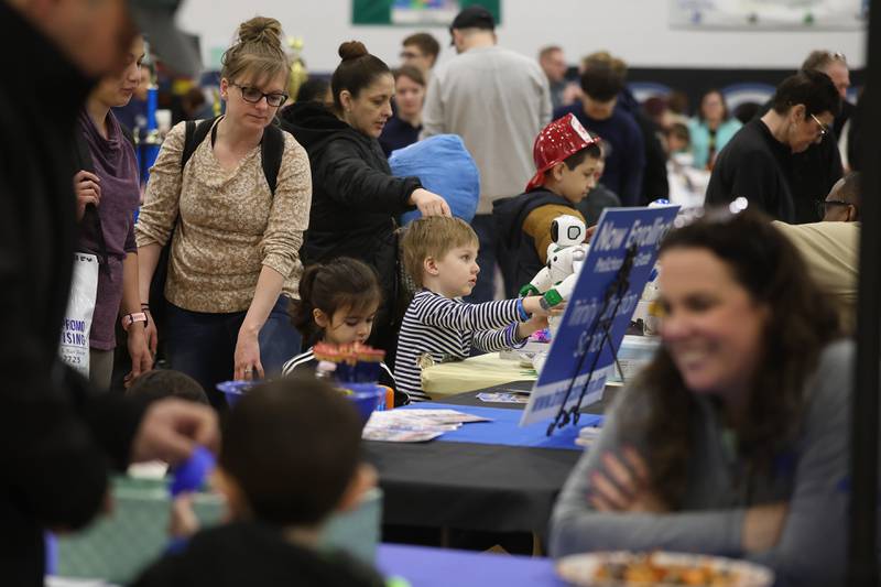 Families browse one of the dozens of local organizations, businesses, and government agencies tables during the Will County’s annual Kids Fair at Troy Middle School on Monday, Feb. 16, 2026 in Joliet.