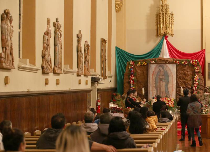 A Mariachi band plays music in front of the Lady Of Guadalupe shrine on Monday, Dec. 12, 2022 at St. Hyacinth Church in La Salle.