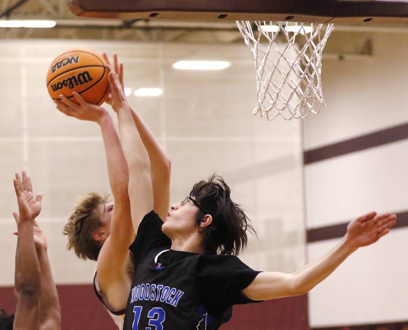 Woodstock's Joesph Nitz tries to block the shot of Richmond-Burton's Luke Robinson during a Kishwaukee River Conference basketball game on Wednesday, Feb. 5, 2025, at Richmond-Burton High School.
