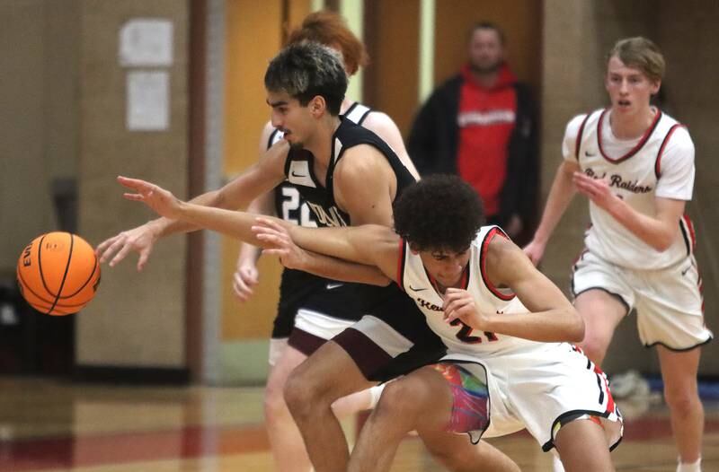 Huntley’s Noah Cook, right, battles Prairie Ridge’s Jose Esparza in varsity boys basketball on Tuesday, Feb. 18, 2025, at  Huntley High School in Huntley.