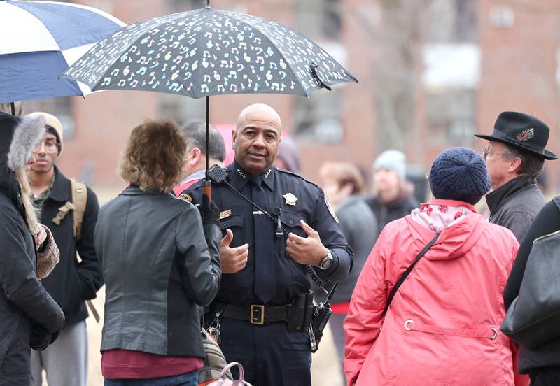 DeKalb Police Chief David Byrd talks to family members of the victims during a remembrance ceremony Tuesday, Feb. 14, 2023, at the memorial outside Cole Hall at Northern Illinois University for the victims of the mass shooting in 2008. Tuesday marked the 15th year since the deadly shooting took place on campus which took the lives of five people.