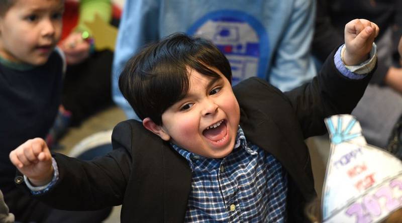 Jesus Rodriguez, 6, enthusiastically rings in the "new year" during a Noon Year's Eve party for kids Friday at the Geneva Public Library. The kids did a 10-second countdown to noon, followed by a balloon drop. Rick West | Staff Photographer