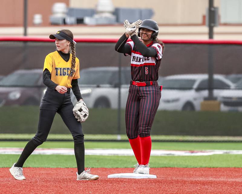 Yorkville's Liv Lathen (5) gestures to the dugout after arriving at second during softball game between Joliet West at Yorkville on Wednesday, April 30, 2025 in Yorkville.