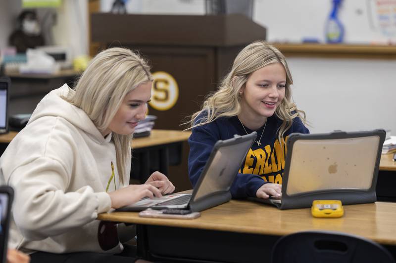 Students Carley Sullivan (left) and Kendall Anderson work on a project in Sterling High School’s Publications class Friday, Feb. 7, 2025.