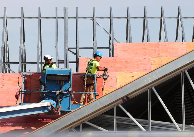 Irving Construction employees work on the roof of the new DeKalb fire station Wednesday, Sept. 18, 2024, at 1130 South Malta Road in DeKalb. Construction on the station, the fourth for the DeKalb Fire Department, is ongoing.