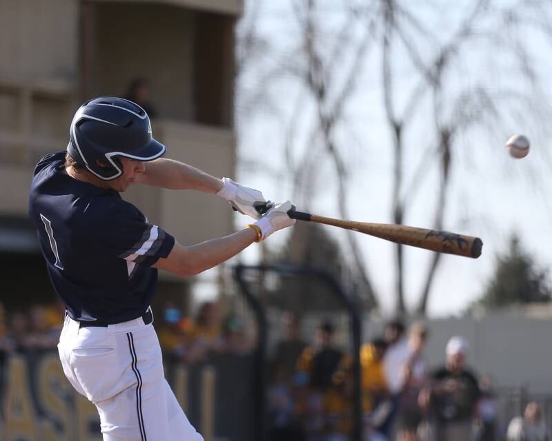 Oswego East's Mike Polubinski (1) connects on a pitch during varsity baseball game between Oswego East at Joliet West.  April 10, 2023.