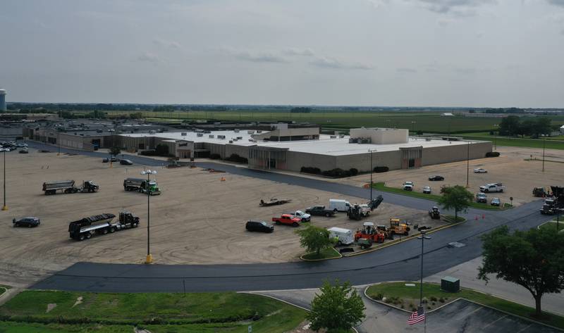 Workers with Advanced Asphalt pave the north entrance to the Peru Mall on Monday, July 17, 2023 in Peru. The project is on private property and is not city funded.
