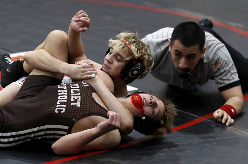 Marian Central's Austin Hagevold tries to pick Joliet Catholic's Maddux Tindal in their 120-pound match during a triangle wrestling meet on Saturday Jan. 11, 2025, between Marian Central, Joliet Catholic, and Mt. Carmel at Marian Central High School in Woodstock.