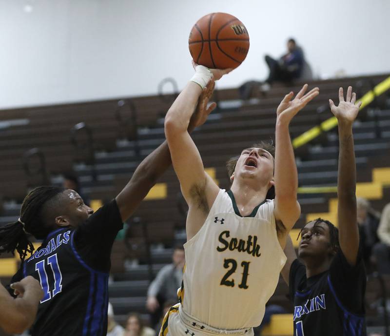 Crystal Lake South's Cooper LePage drives to the basket between’s Larkin’s Adrian York and Joshua Hibbett during a Hinkle Holiday Classic basketball game Wednesday, Dec. 28, 2022, at Jacobs High School in Algonquin.