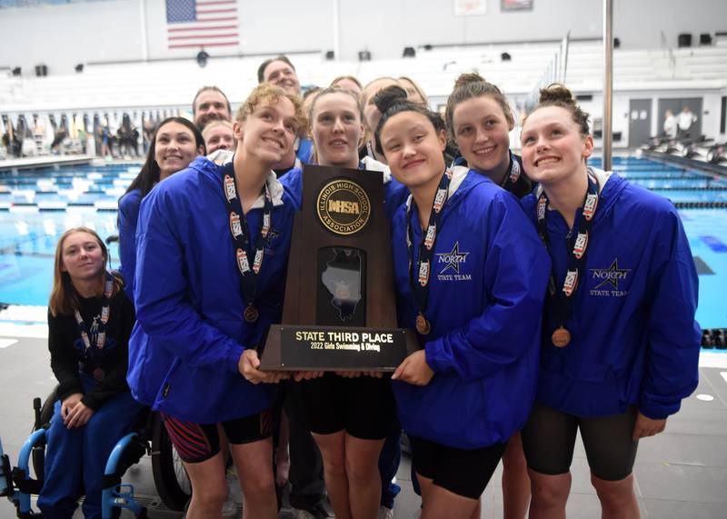 St. Charles North swimmers hold their third-place trophy during the IHSA girls state swimming finals at FMC Natatorium in Westmont on Saturday, Nov. 12, 2022.