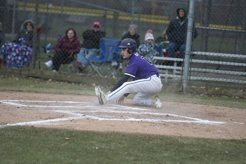 Dixon's Bryce Feit slides in safely at home on a passed ball Tuesday, April 5, 2022 against Oregon.