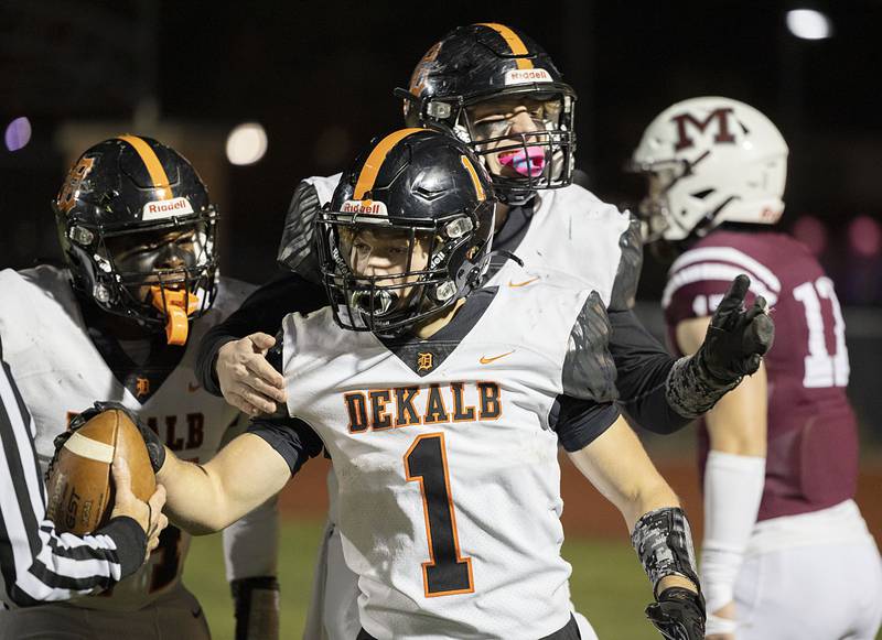 DeKalb's Talen Tate celebrates with teammates after scoring Friday, Oct. 28, 2022 in round one of the football playoffs against Moline. The TD was the second of the first half for the Barbs.