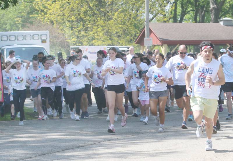 Runners begin to race during the Color Fun Run on Sunday, April 26, 2026 at Lake Mendota.