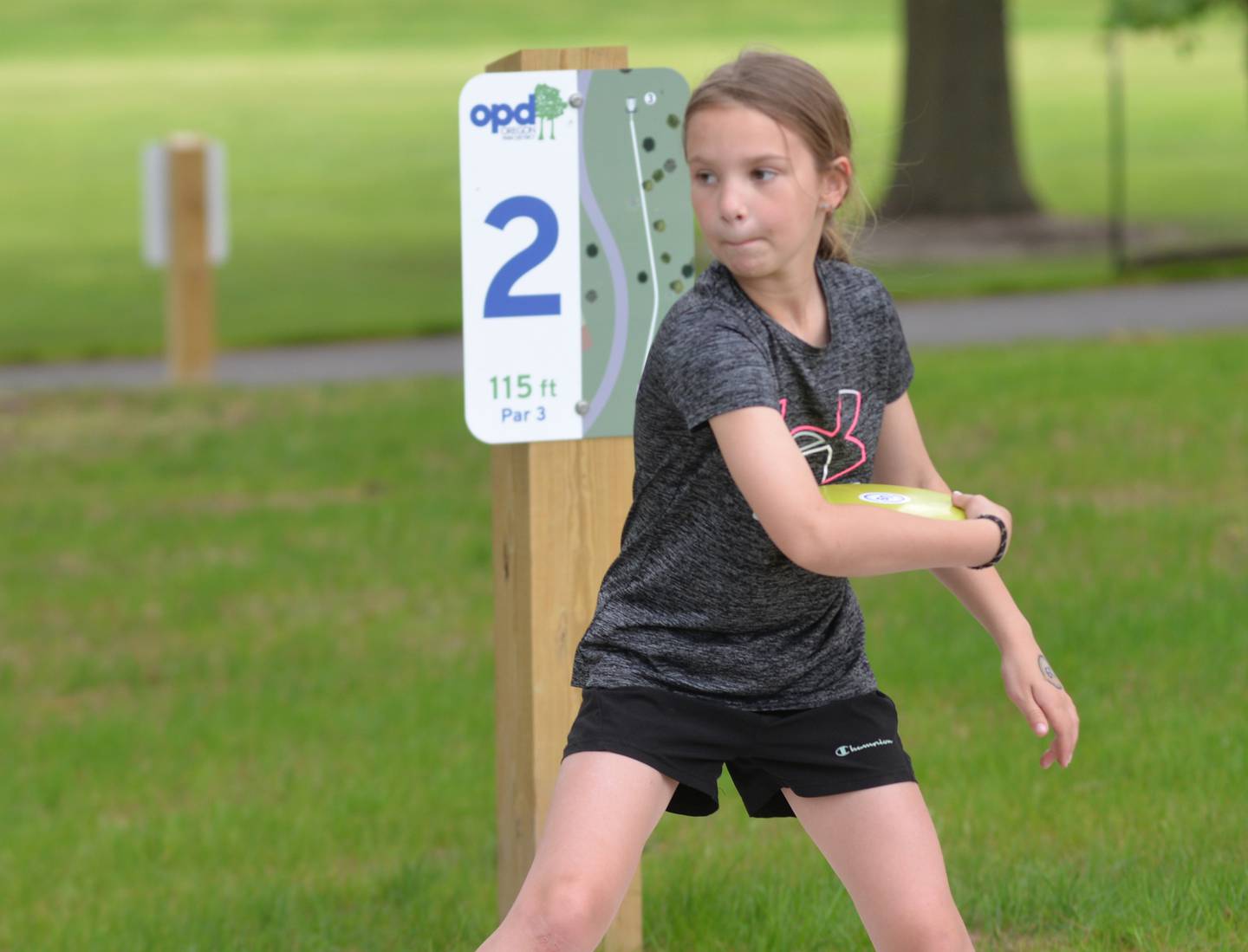 Wyatt Hendricks, 8, of Oregon, tries out the new disc golf course at the recently upgraded Oregon Park East Inland Side recreation area during a grand opening event on Monday, May 18, 2026.