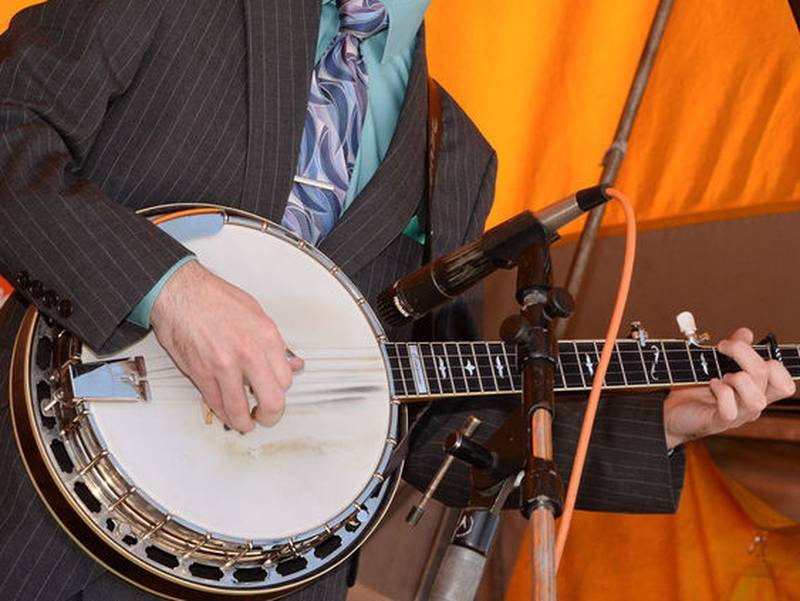 Strumming on his banjo, Jacob Underwood, a member of the Bluegrass Express, a musical group from Galena, entertained the crowds during the Burgoo Festival in Utica Sunday.