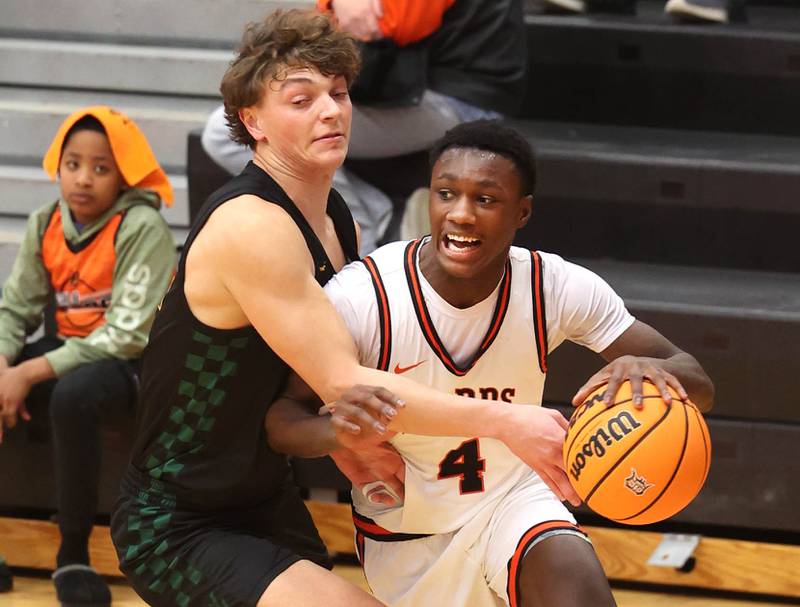 DeKalb's Marquise Bolden goes baseline against Waubonsie Valley's Tyus Payne during their game Friday, Feb. 21, 2025, at DeKalb High School.