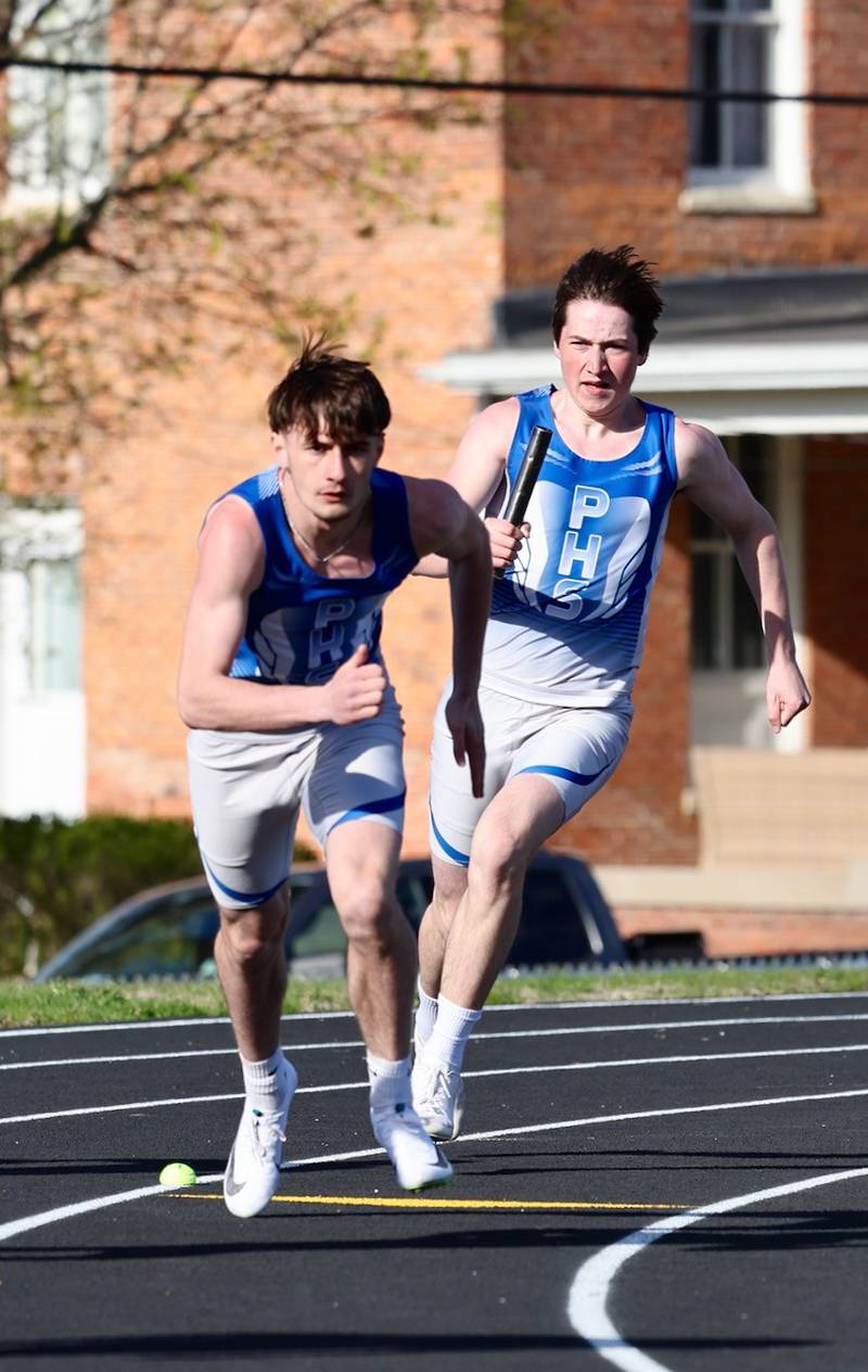 Gavin Lanham takes a handoff from Princeton teammate Alex Winn in Tuesday's Howard-Monier Invite.