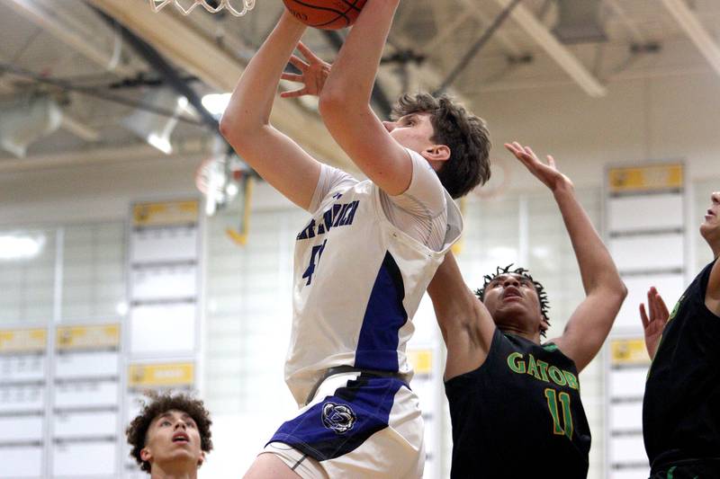 Lake Zurich’s Anton Strelnikov gets past Crystal Lake South’s Christian Rohde in Hinkle Holiday Classic boys basketball tournament game action at Jacobs High School Wednesday.